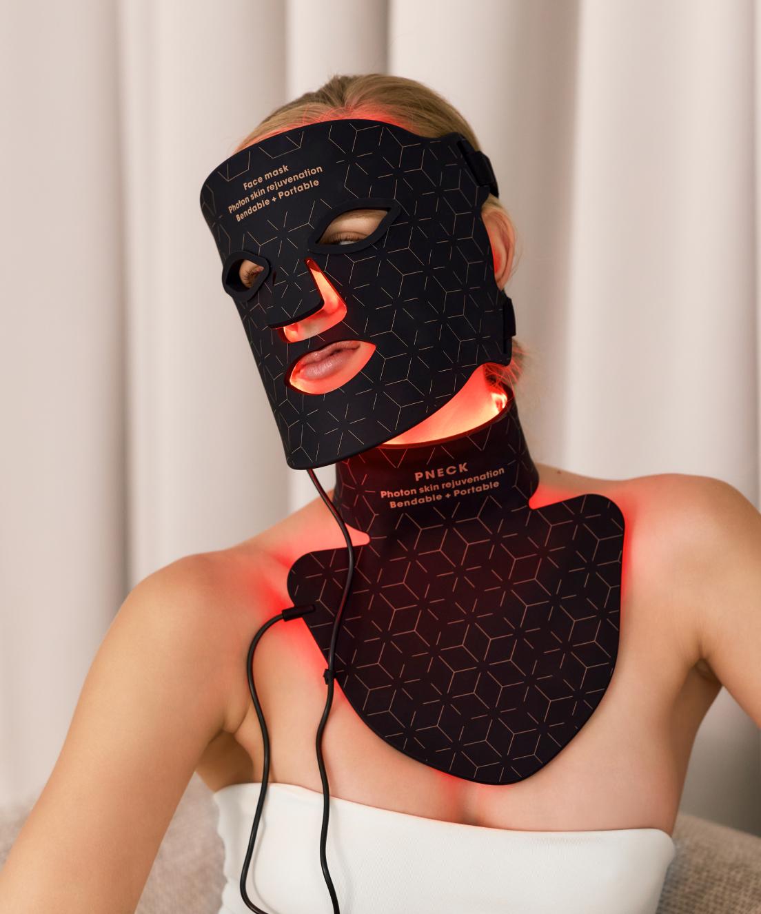 "Happy woman using Juvine red light phototherapy neck mask for skin rejuvenation and anti-aging at home."